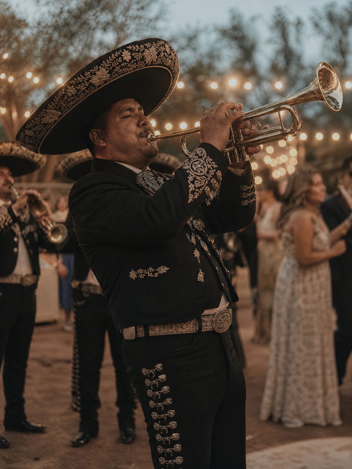 A mariachi musician performing at a wedding reception